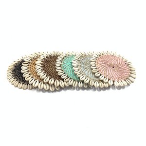 Rotan onderzetter met kauri schelpen
