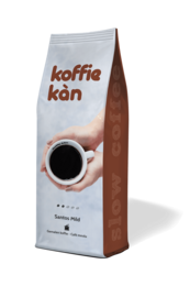 Coarsely ground coffee beans in a brown and white package labeled "Koffie kan". The coffee appears to be a medium roast.