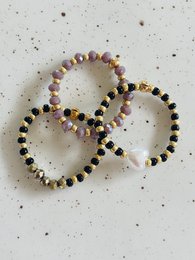 Stacked rings with a double sparkle design, featuring a mix of colorful beads in various shapes and sizes.