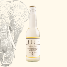 A clear, glass bottle with a white label featuring the text "KUGI ELEPHANT GINGER | LIME" against a vibrant, yellow background with sliced limes and other citrus fruits.