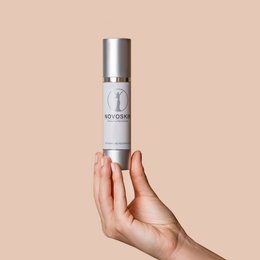 Antiaging night cream in a silver and white bottle. Moisturizing and rejuvenating formula for mature skin.