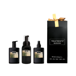 A deluxe gift set containing a variety of beauty products, including a black box with a yellow ribbon. The set includes various skincare items in dark-colored bottles.