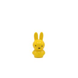  Yellow plush bunny figurine with long ears and a simple, minimalist design.