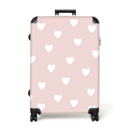  A light pink suitcase with a heart pattern, available in 3 sizes (62x83 cm, 53x72 cm, 45x61 cm). The suitcase has 4 wheels for easy mobility.