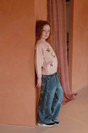  Blue denim jeans for kids, featuring a repeating bow pattern print. Elastic waistband for comfort and easy wear.
