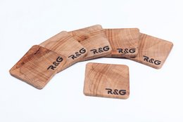 Set of 6 wooden coasters with "R&G" logo, made of natural wood material.
