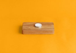 Rectangular wooden storage basket with a single white oval accent.
