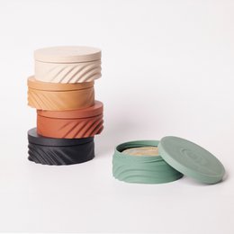 Round, portable soap travel case in ebony, cedar, and birch wood finishes.