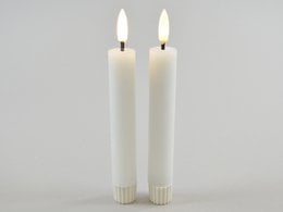 Two white LED candles with a green, moss-like exterior. The candles are cylindrical in shape and measure approximately 2.2 x 16.5 cm. They have an on/off/timer switch and require 1 AAA battery.