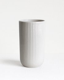 A white ceramic mug with vertical ribbed texture, suitable for hot or cold beverages.