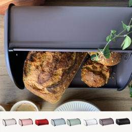 Cream-colored metal bread box with a roll-top lid. Available in various colors including rose, red, ice, leaf, white, almost black, and black.