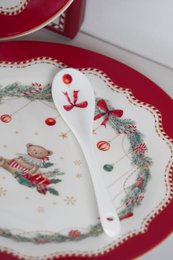  A white porcelain dessert spoon with a red bow design, measuring 13 cm in length.