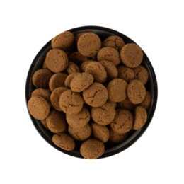  Round, brown cookies in a black bowl. Spice-flavored cookies, traditional Dutch kruidnoten.