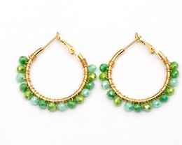  Stainless steel gold-colored statement earrings with an oval design. The earrings feature a textured, hammered finish for a unique, eye-catching look.