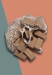 Wooden building blocks in a mesh bag, featuring a variety of shapes and textures. Ideal for creative play and development of fine motor skills in young children.