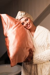 Soft, luxurious silk pillowcase in a neutral color, perfect for a comfortable and relaxing sleep experience.