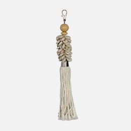 White tassel keychain with wooden beads and seashell accents.