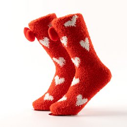  Red fuzzy socks with white heart patterns. One size fits most.