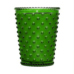 A tall, round glass candle in a chestnut color with a hobnail texture and pattern. The candle has a rustic, vintage-inspired design.