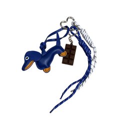  Blue leather charm in the shape of a dolphin with a metal tag and rope detail.