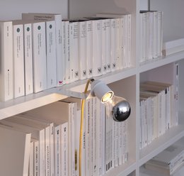White bookend with a built-in light fixture, featuring a simple, minimalist design.
