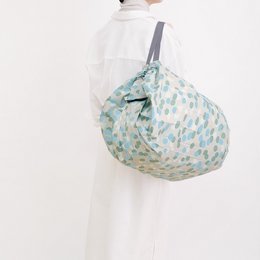 Foldable shopping bag in a light blue and white polka dot pattern, with a compact and portable design.