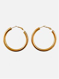 Large gold-tone hoop earrings with a simple, classic design. These statement earrings feature a round, continuous loop shape that creates a bold, eye-catching look.