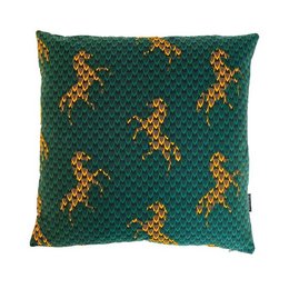 A decorative green cushion with a repeating pattern of golden horses.