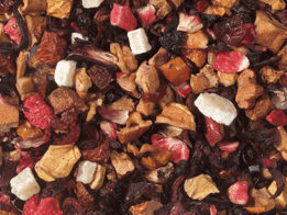 A colorful assortment of dried fruit pieces, including strawberry, orange, and other vibrant hues. The mix appears to be a tea or herbal infusion blend, with a variety of textures and flavors.
