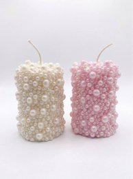  Pearl textured pillar candles in cream white and dusty pink, cylindrical shape with beaded surface finish.