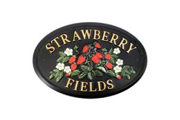  Oval metal wall sign with "Strawberry Fields" text and floral design in vibrant colors on a black background. Measures approximately 20x30 cm.