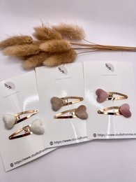  Hair clips in white, soft pink, and beige colors with a simple, minimalist design.