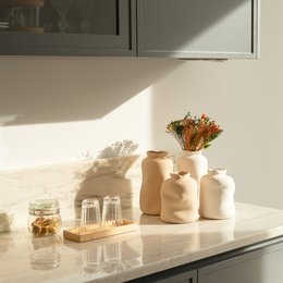 Beige ceramic vase with a simple, minimalist design. Available in small and large sizes.