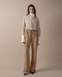  Relaxed, wide-leg beige trousers with a gray v-neck sweater. Comfortable, casual style.