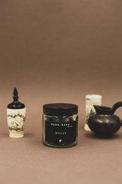 Dried mallow flowers, a natural tea ingredient, available in 250ml and 125ml sizes, with a dark glass jar and a ceramic jar with a floral design.
