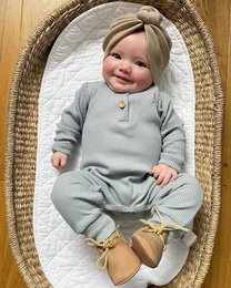 Grey ribbed romper for baby, 0-18 months, soft cotton material, simple design with snap closure.
