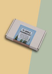 A jungle-themed candle kit containing a round, tall candle in a green and blue color scheme.