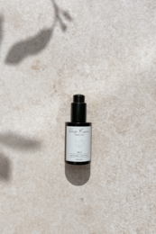  A deep repair face oil with a sleek, minimalist design. The product features a black bottle with a simple label, indicating a high-quality, nourishing facial oil.