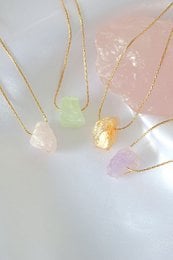 Raw natural crystals in 24K gold pendant necklaces. Available in Amazonite, Citrine, Rose Quartz, and Amethyst. Unique, minimalist jewelry with natural gemstones.