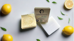  Organic certified solid soap bar with lemon, lime, and calendula flowers. Rectangular shape, pale yellow color, natural ingredients.