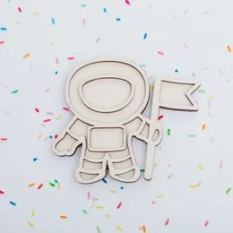 Wooden astronaut-shaped sensory toy with flag and rocket ship accessories.