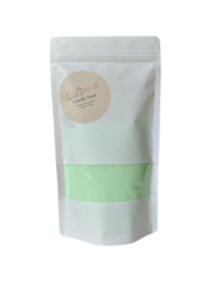 Light green tealight candle with a burning sand scent.