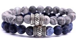 Beaded bracelet set with natural stone beads in gray and blue tones, featuring a textured metal accent bead.