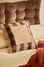 "Square tufted cushion cover, earth tones brown beige, geometric pattern, soft textile"