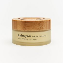 Unrefined, cold-pressed, organic, vegan shea butter cream in a bamboo container.