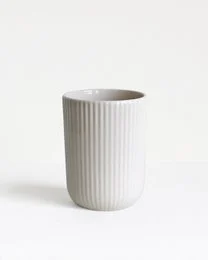 White ceramic mug with vertical ribbed texture, 150 ml capacity.