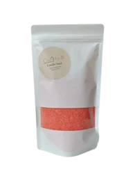 Tall, round, orange/red candle made of burning sand. Suitable for use as a tealight.