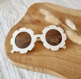 Beige flower-shaped children's sunglasses with UV400 protection.