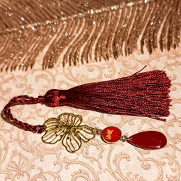 Colorful, decorative bookmarks with tassels, sequins, and floral elements. The bookmarks feature a variety of colors including red, yellow, and purple, and incorporate natural materials like flowers and beads.