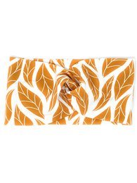 Organic cotton headband with geometric leaf pattern in warm orange tones.